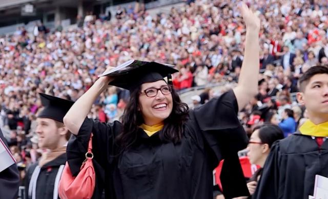Student waves at graduation