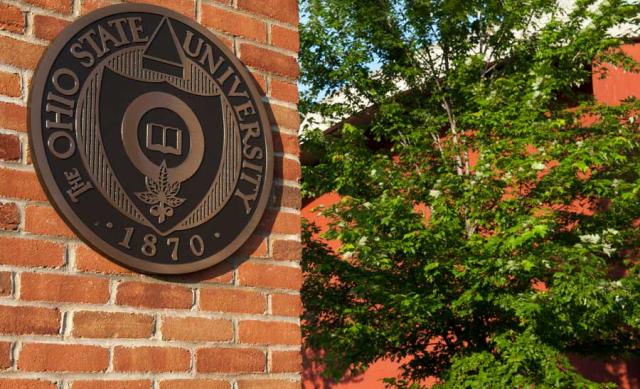 Photo of the University Seal on a brick wall