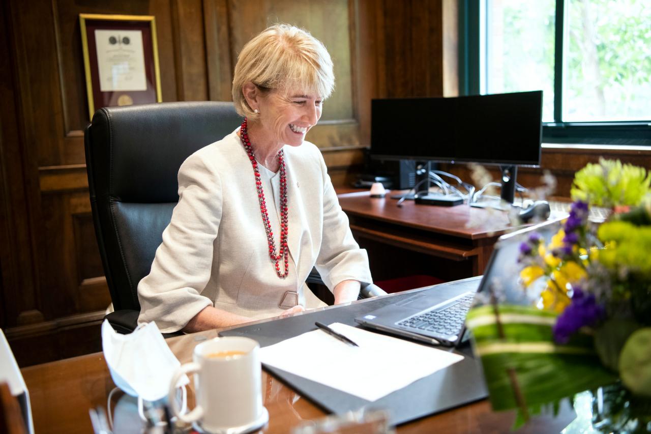 Dr. Kristen M. Johnson sitting at her desk attending a zoom meeting