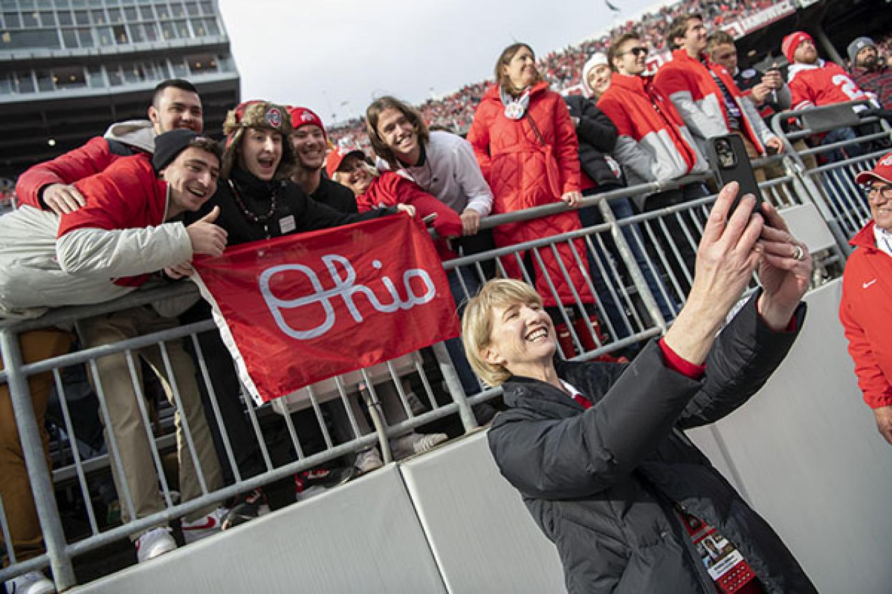 President Johnson taking a selfie with students at Ohio Stadium