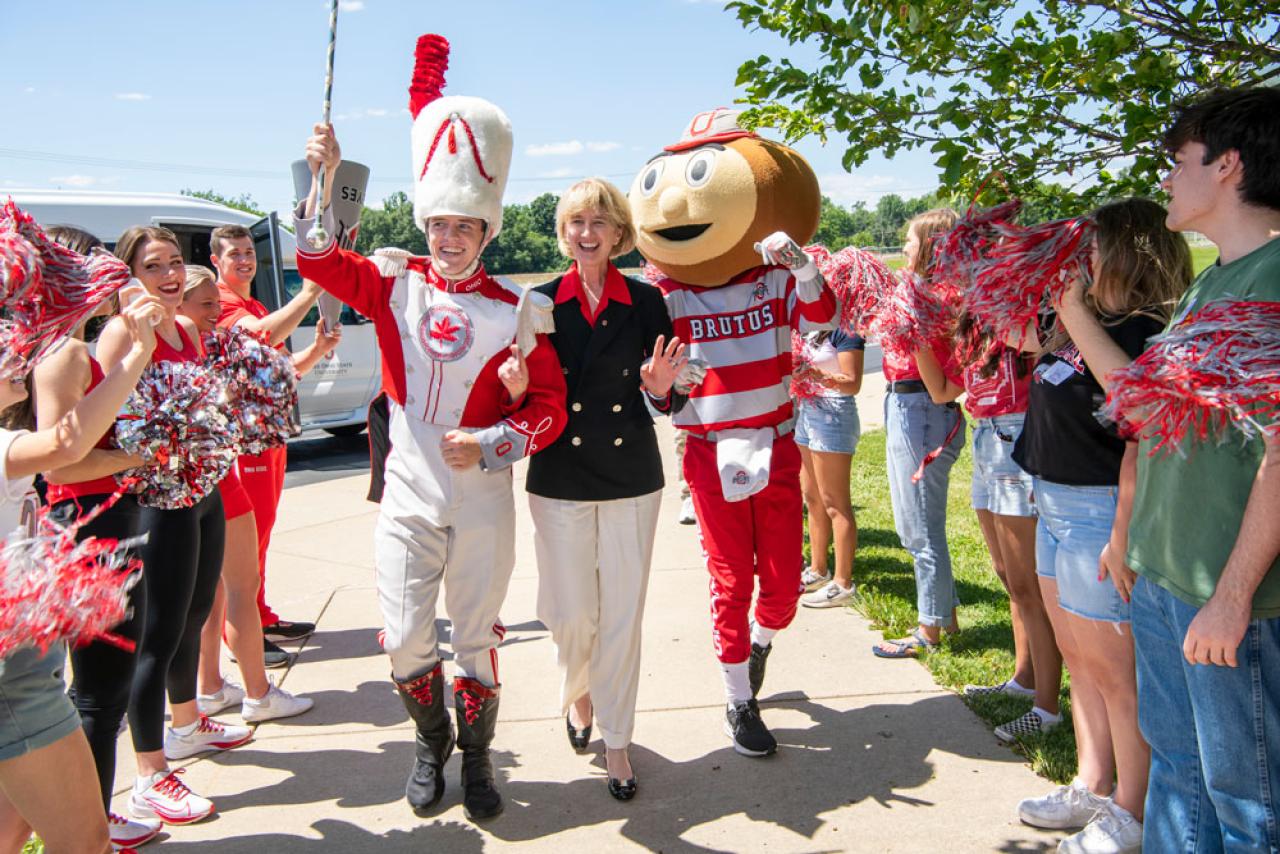 President Johnson, Brutus and the Ohio State Marching Band drum major arriving at a State Tour stop.