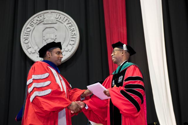 President Drake shaking hands with graduate