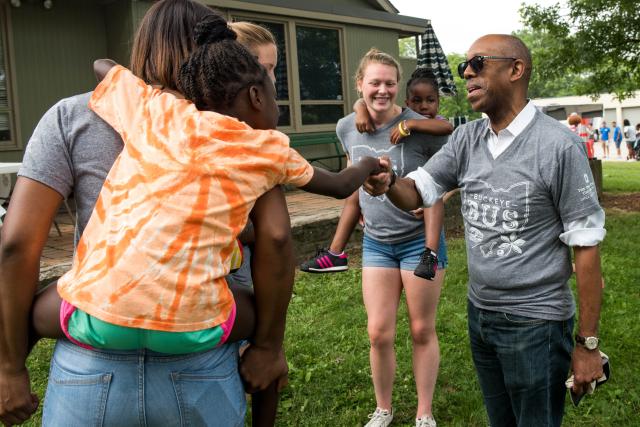 President Drake shaking hands with child