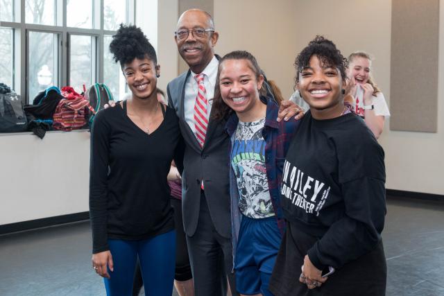President Drake with three students