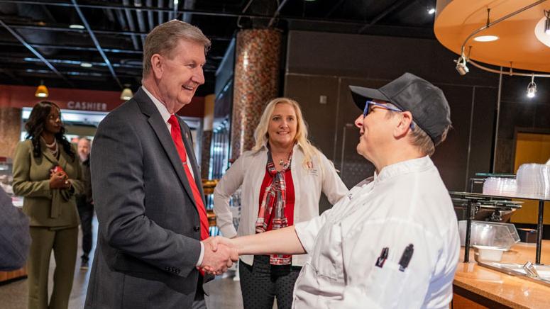 President Ted Carter shakes hands with a cook at the Ohio Union