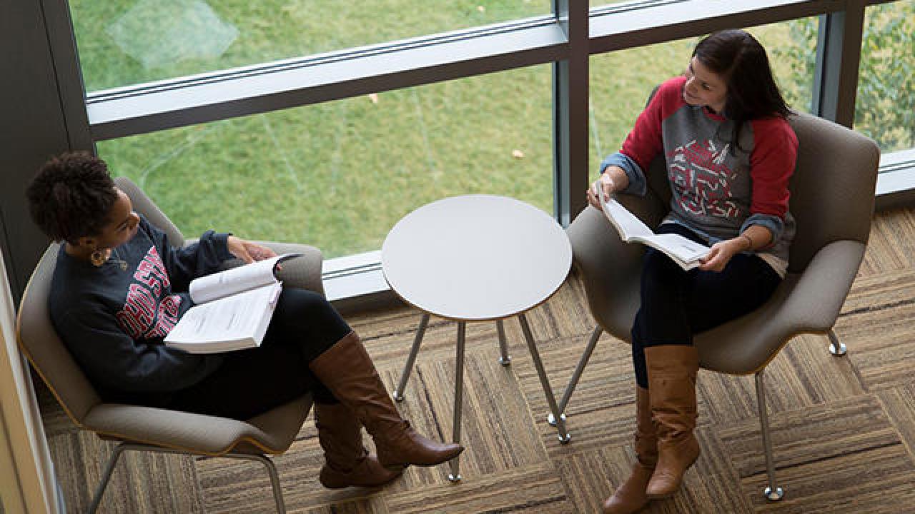 Two people talking while sitting in chairs