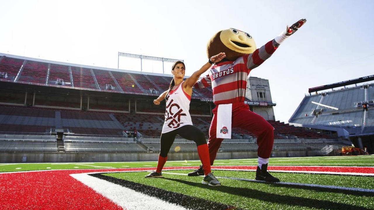 Student and Brutus doing yoga at Ohio Stadium