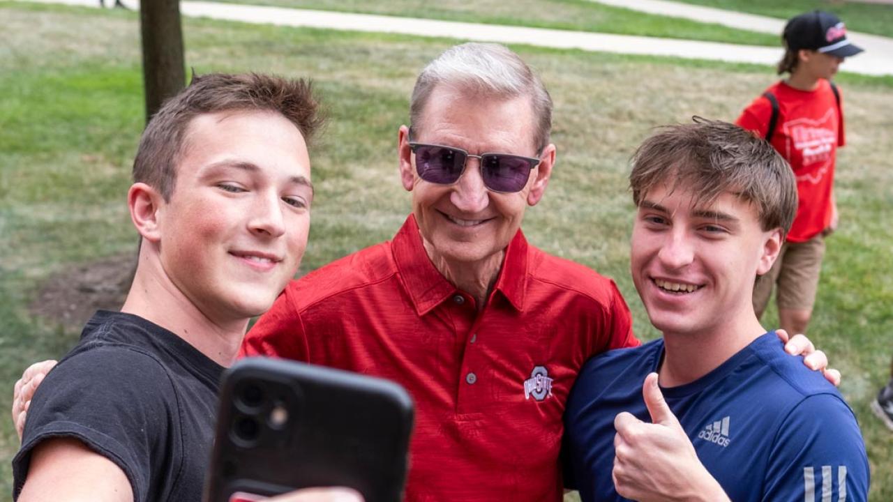 Ohio State President Ted Carter taking a selfie with two students on move-in day 2024