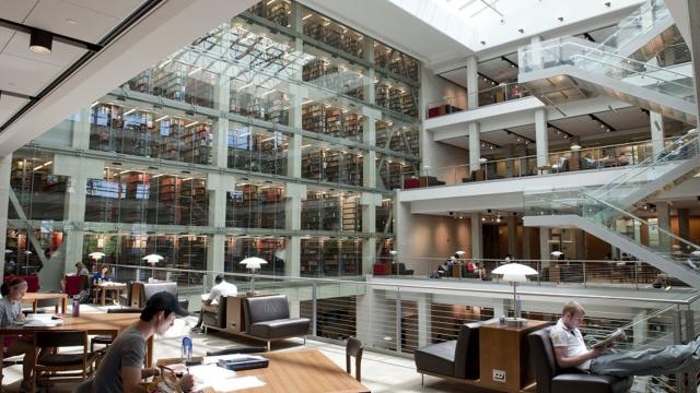Image of students studying off the main staircase at Thompson Library
